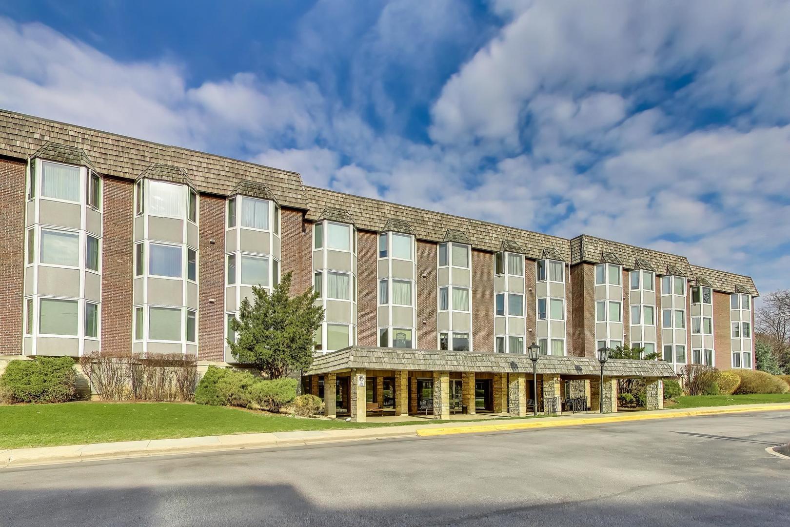 400 Ascot Drive, Unit 1M Park Ridge, IL 60068 - Photo 2 of 37 a front view of a building with a garden