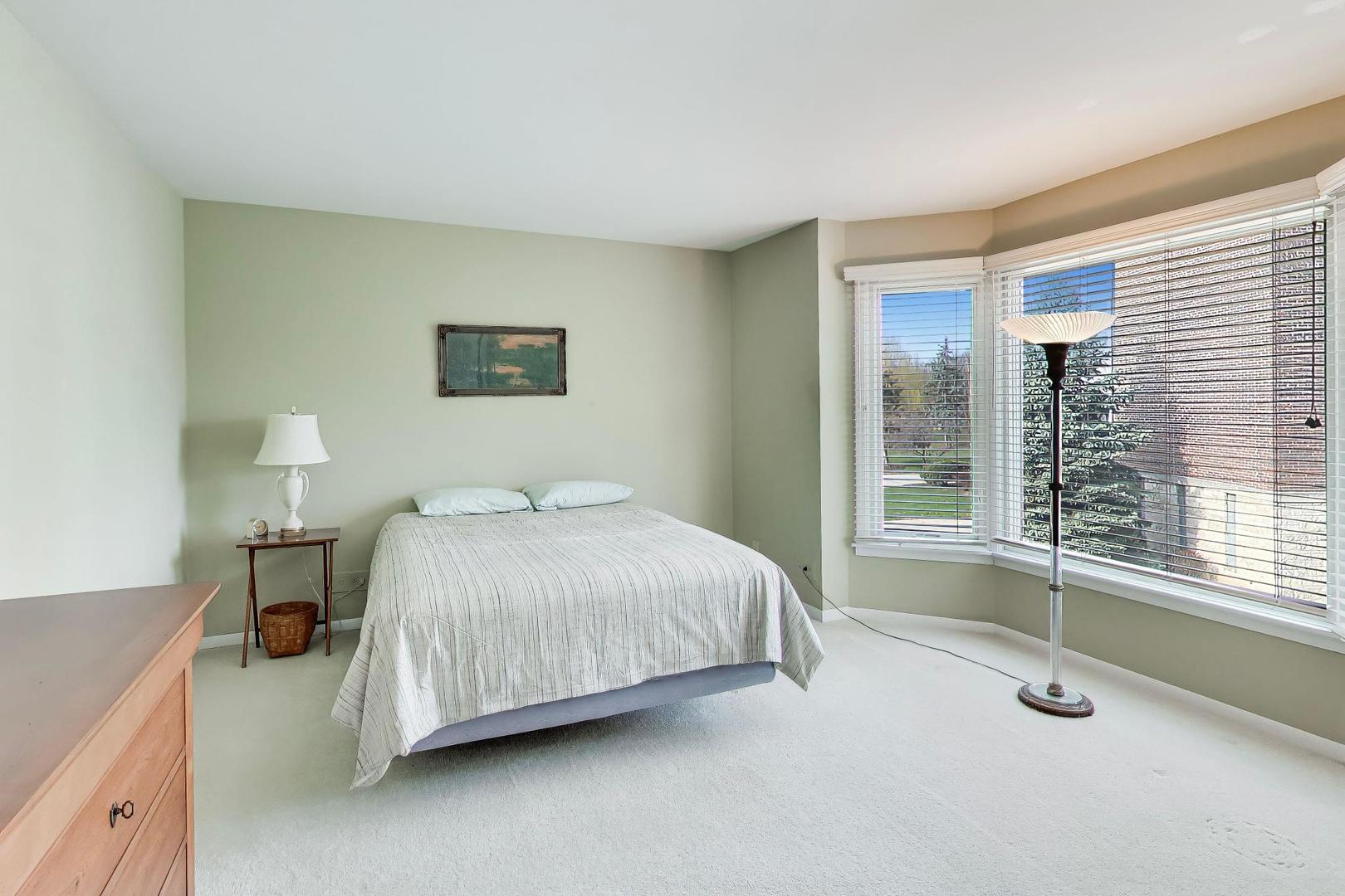 400 Ascot Drive, Unit 1M Park Ridge, IL 60068 - Photo 23 of 37 a bedroom with a bed and a window