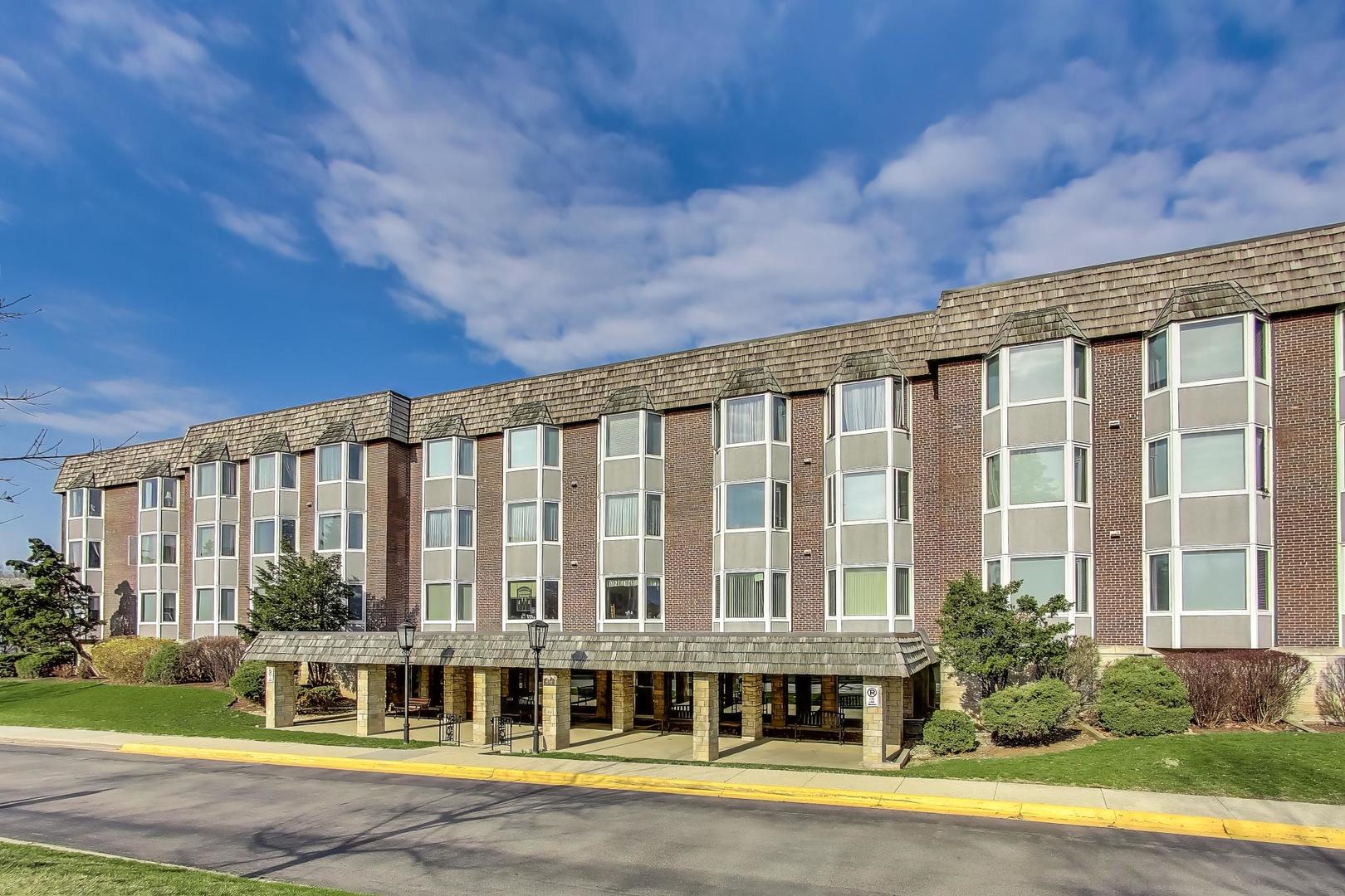 400 Ascot Drive, Unit 1M Park Ridge, IL 60068 - Photo 3 of 37 a large building with a large window and yard