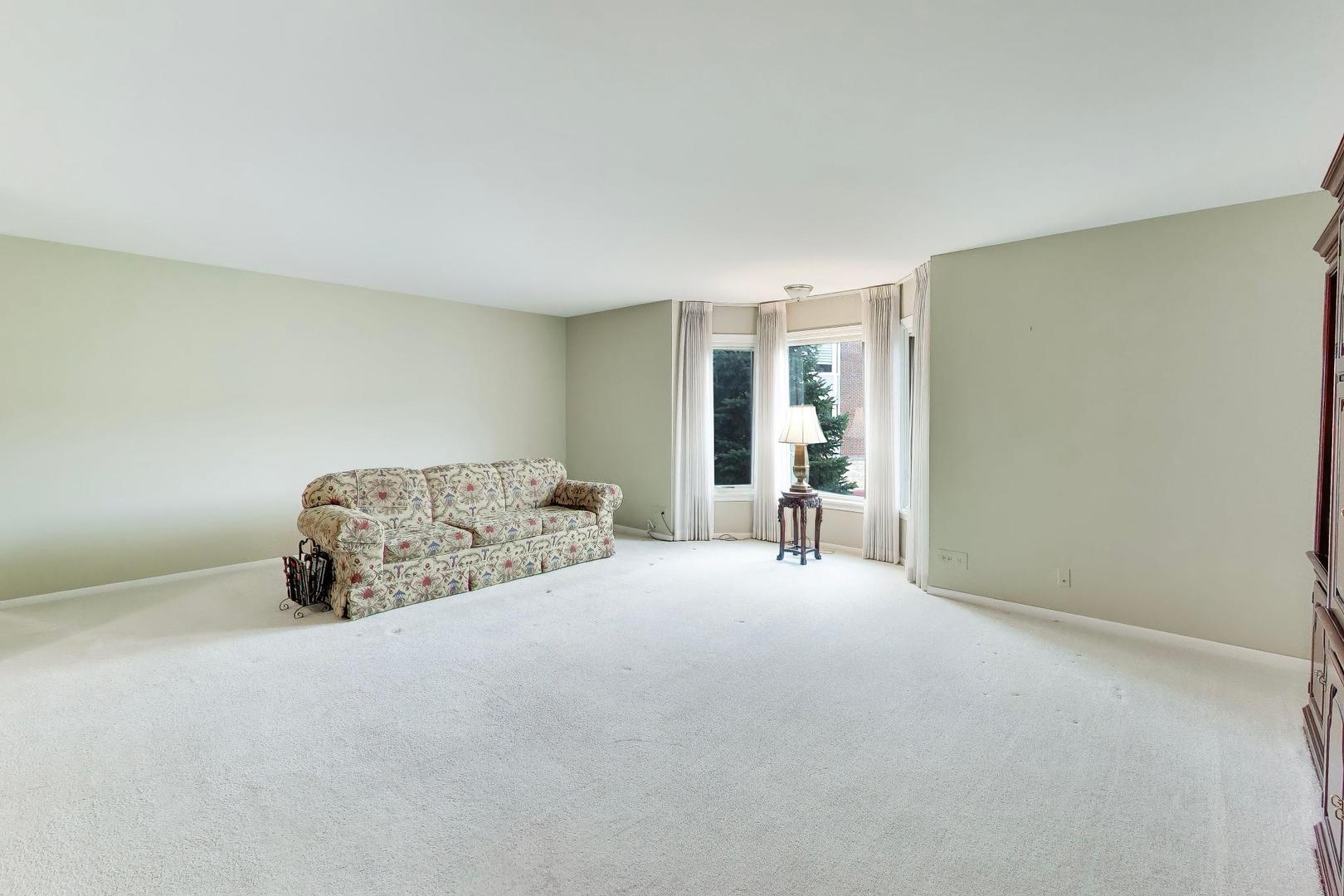 400 Ascot Drive, Unit 1M Park Ridge, IL 60068 - Photo 10 of 37 a bedroom with a bed and a table
