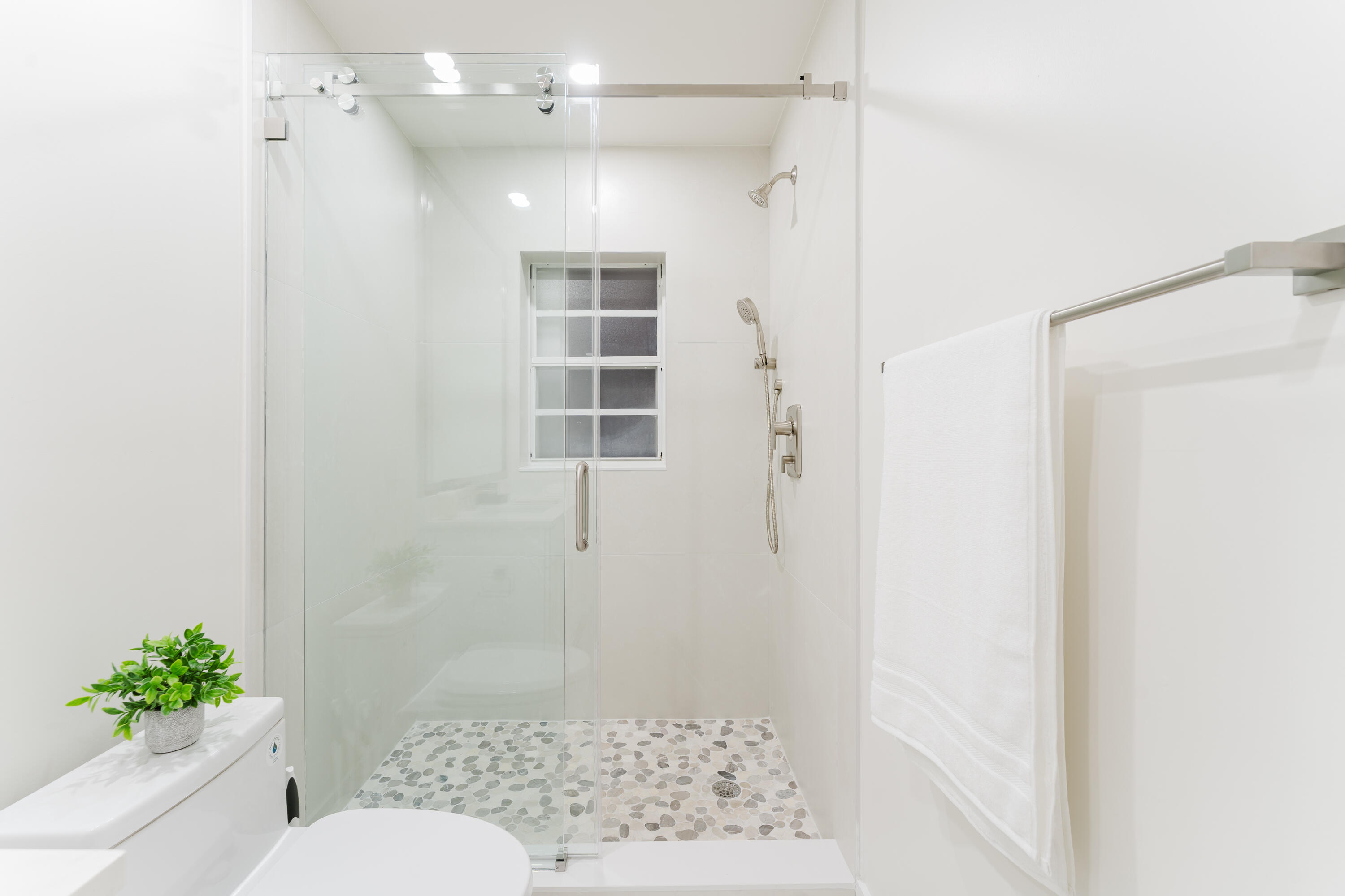3199 Northeast 6th Drive Boca Raton, FL 33431 - Photo 29 of 49 a bathroom with a shower and a toilet