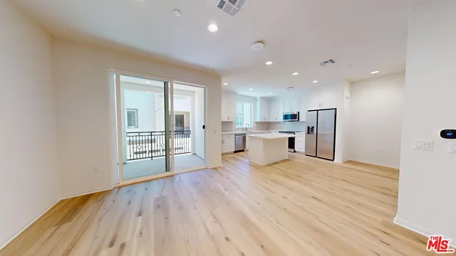 a view of a kitchen with a sink and wooden floor
