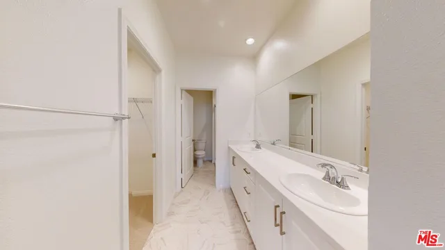 a bathroom with a double vanity sink mirror and double