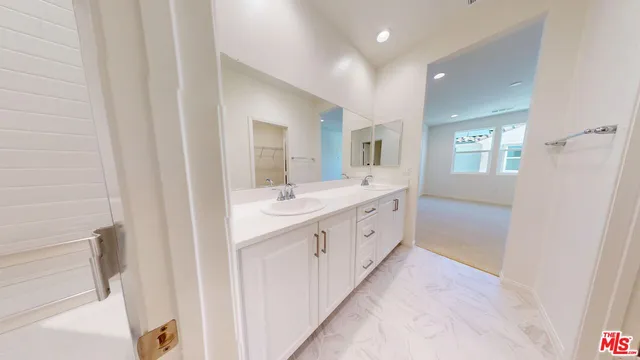 a bathroom with a double vanity sink a and a mirror