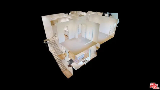 a bed sitting in a bedroom next to a white wall