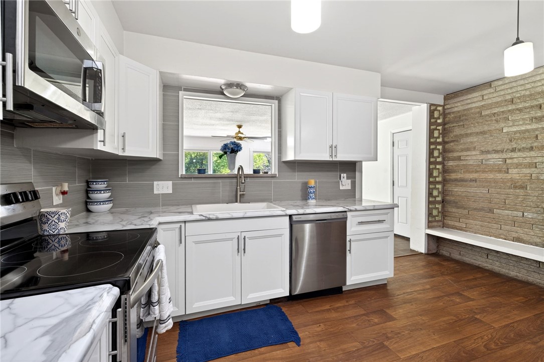 2684 Arthur Road Springfield, OH 45502 - Photo 19 of 69 This bright kitchen features sleek appliances, ample storage, and a striking stone accent wall.