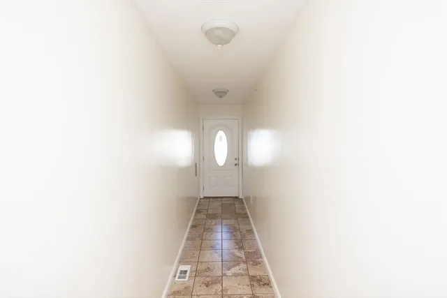a view of a hallway with granite countertop