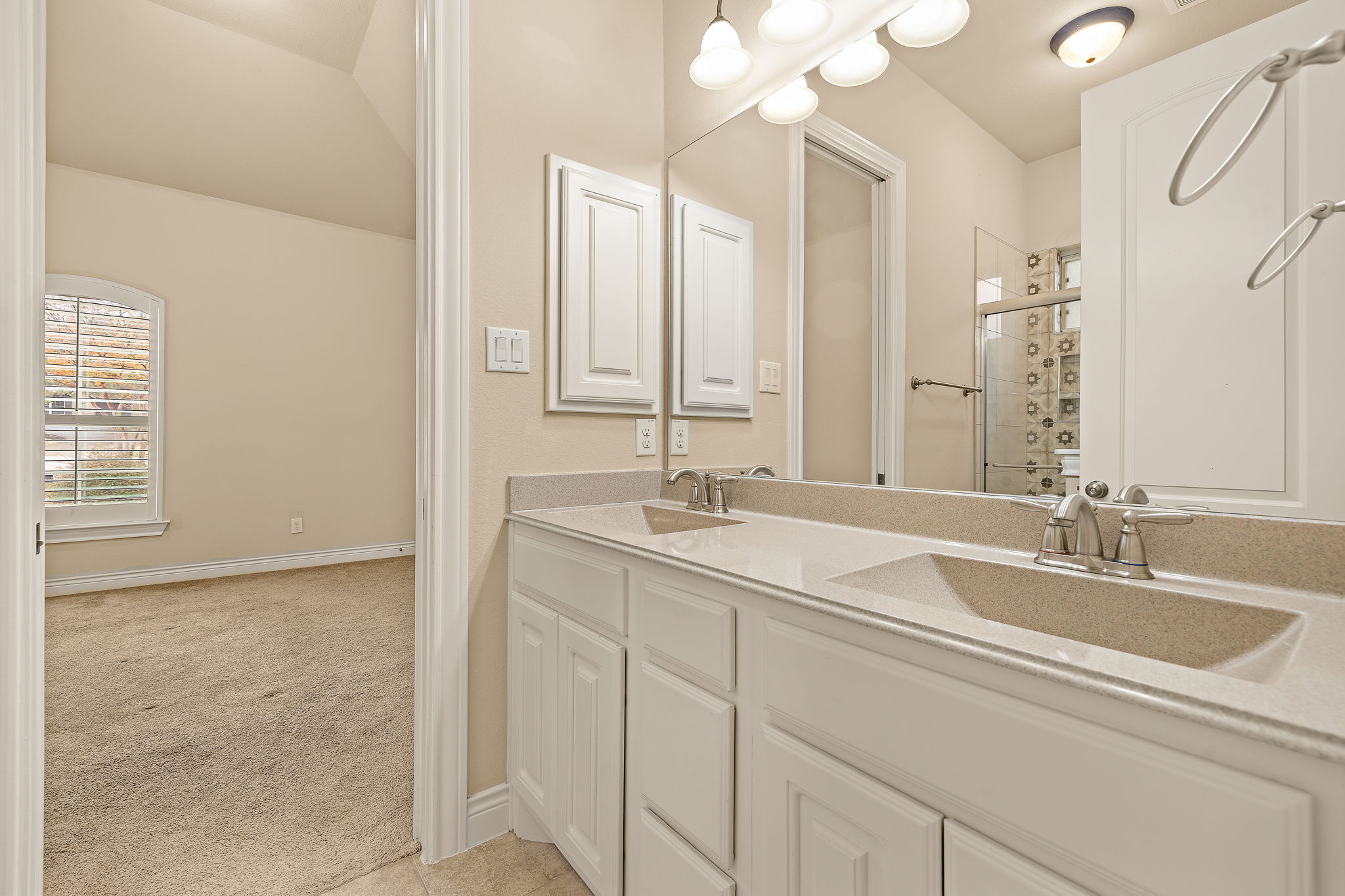 174 Estrella Crossing Georgetown, TX 78628 - Photo 22 of 38 Full bathroom featuring light colored carpet, double vanity, a stall shower, and lofted ceiling