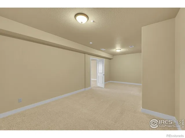a view of a house with wooden floor next to a yard
