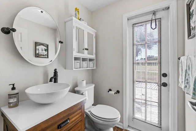 a view of washer and dryer with bathroom in the background