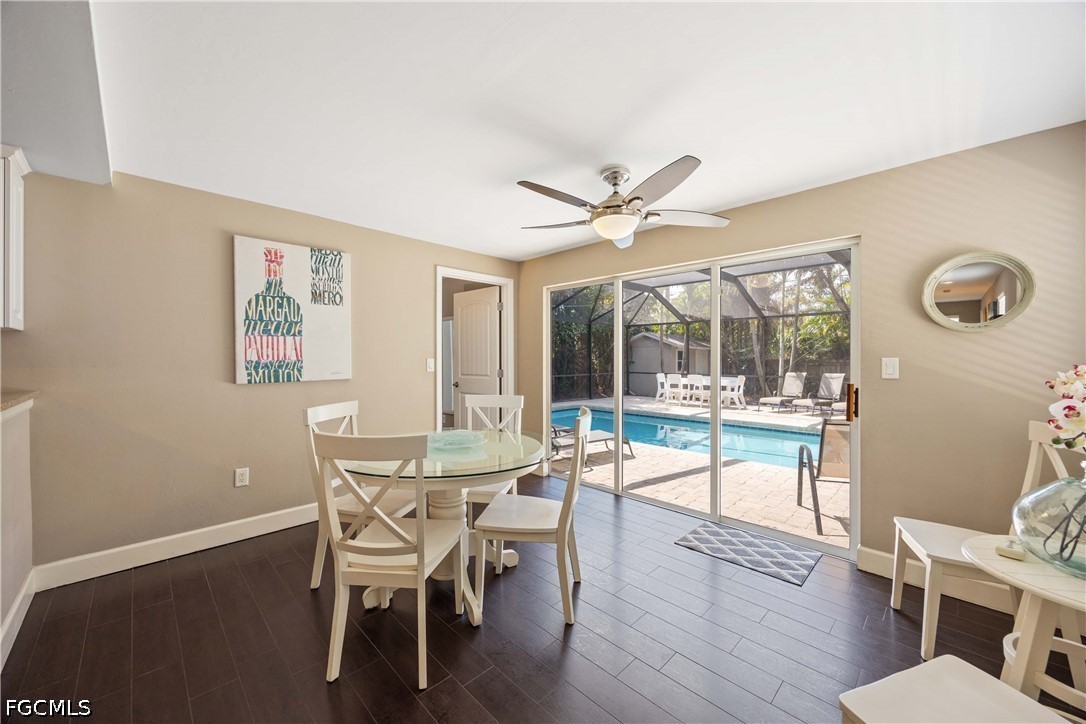 856 104th Avenue North Naples, FL 34108 - Photo 11 of 35 a dining room with wooden floor a chandelier a glass table and chairs
