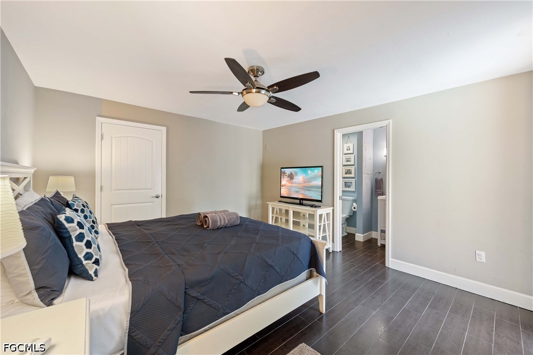 856 104th Avenue North Naples, FL 34108 - Photo 12 of 35 a bedroom with a bed and wooden floor