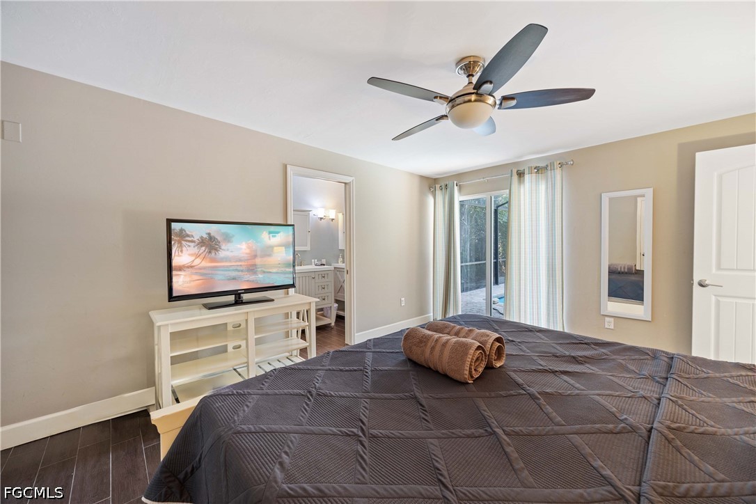 856 104th Avenue North Naples, FL 34108 - Photo 13 of 35 a bedroom with a bed and a flat screen tv