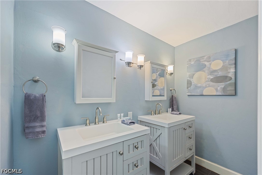 856 104th Avenue North Naples, FL 34108 - Photo 14 of 35 a bathroom with a sink and a mirror