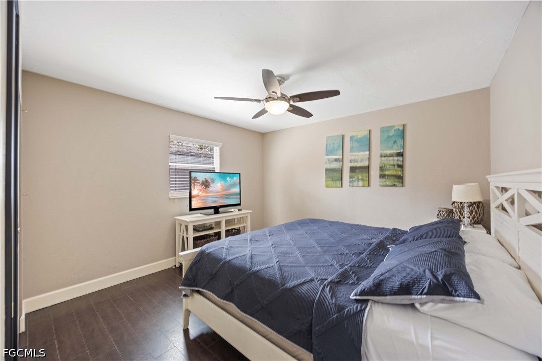 856 104th Avenue North Naples, FL 34108 - Photo 16 of 35 a bedroom with a bed and a chandelier