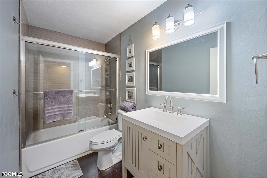 856 104th Avenue North Naples, FL 34108 - Photo 17 of 35 a bathroom with a sink a toilet a mirror and shower