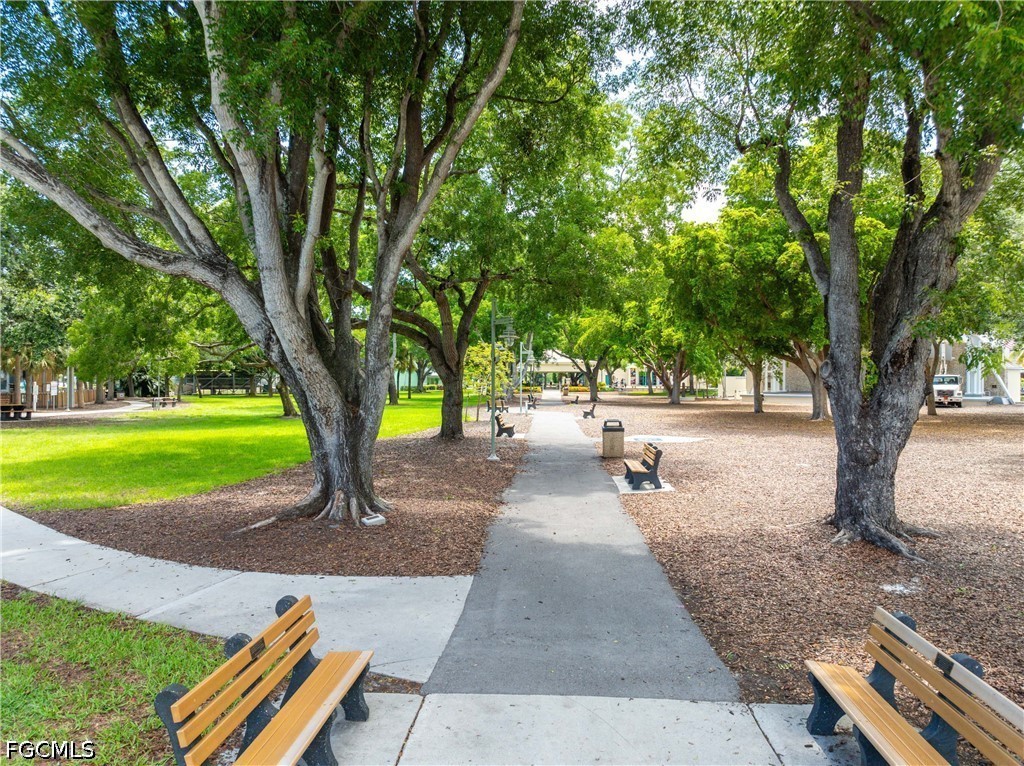 856 104th Avenue North Naples, FL 34108 - Photo 30 of 35 a park with large trees and a bench