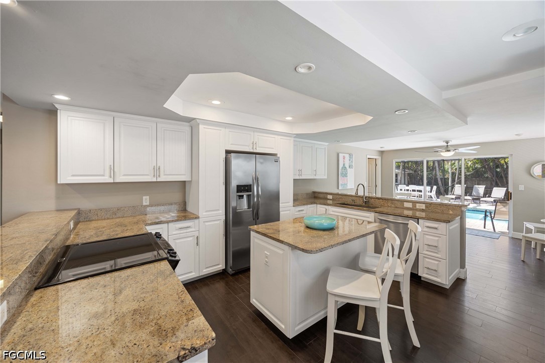856 104th Avenue North Naples, FL 34108 - Photo 7 of 35 a kitchen with a dining table chairs refrigerator and cabinets