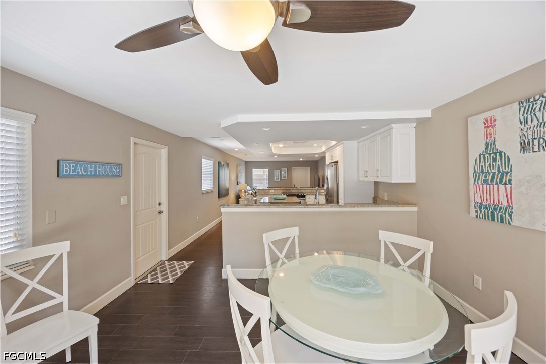 856 104th Avenue North Naples, FL 34108 - Photo 10 of 35 a dining room with wooden floor furniture and a chandelier