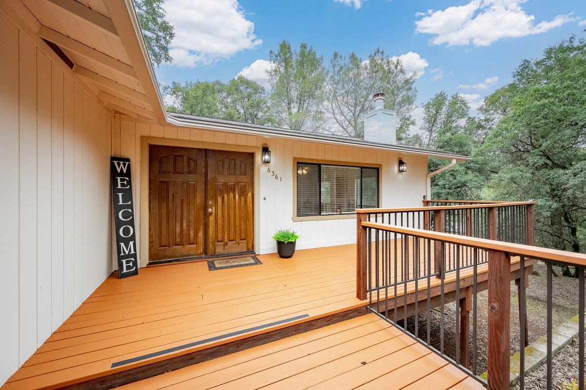 a view of a house with wooden floor and fence