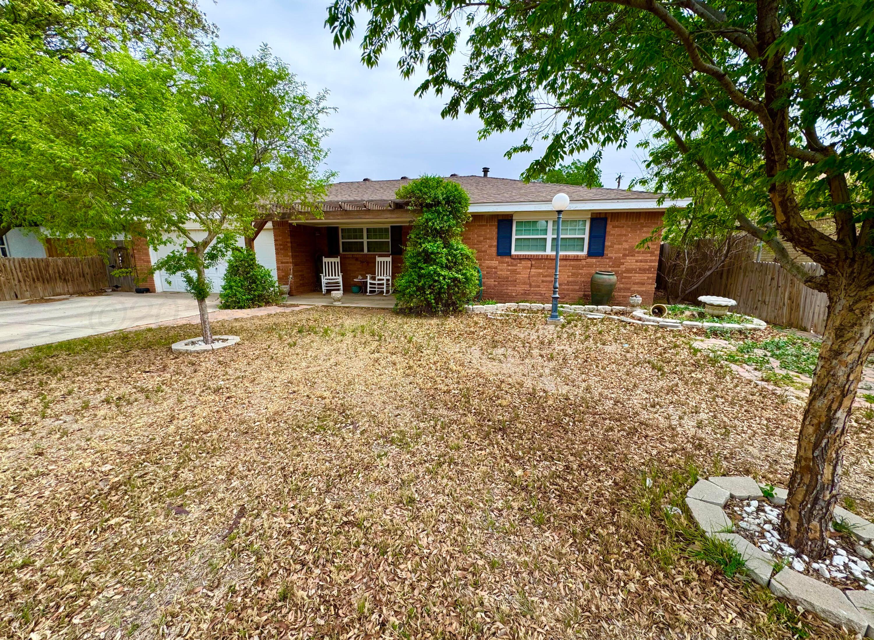 4705 Goodnight Trail Amarillo, TX 79109 - Photo 1 of 10 a front view of a house with a yard and garage