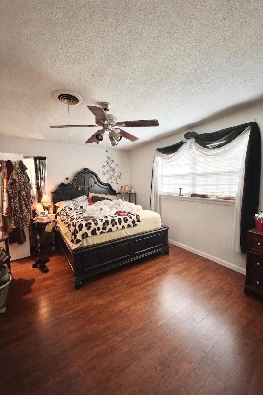 4705 Goodnight Trail Amarillo, TX 79109 - Photo 6 of 10 a bedroom with a bed and a window