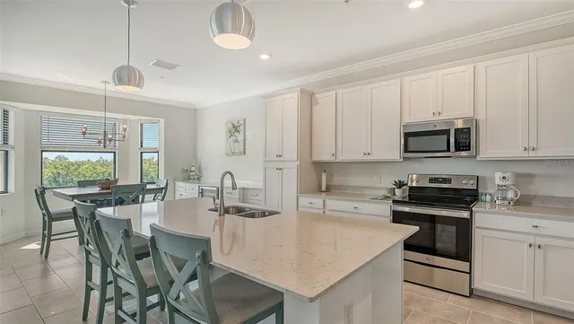 a kitchen with sink and refrigerator