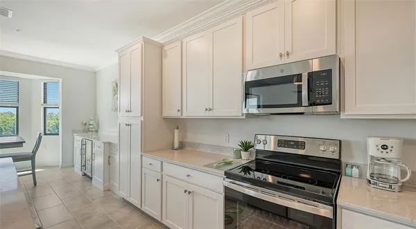 a kitchen with refrigerator a stove a sink and cabinets