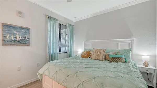 a bedroom with a bed and a lamp on dresser