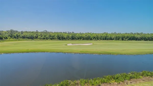 a view of a patio with a table and chairs under an umbrella