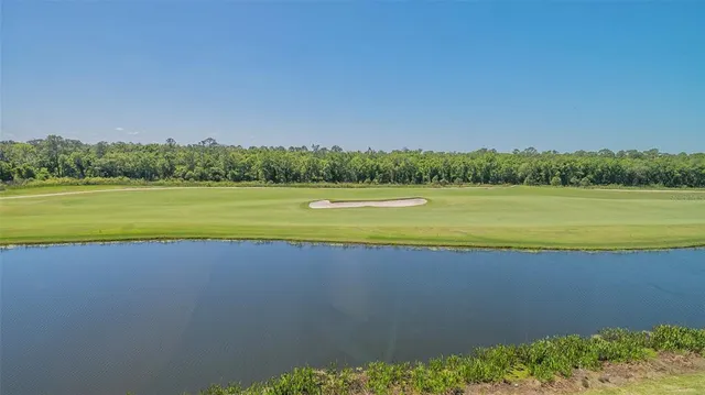 a view of a patio with a table and chairs under an umbrella
