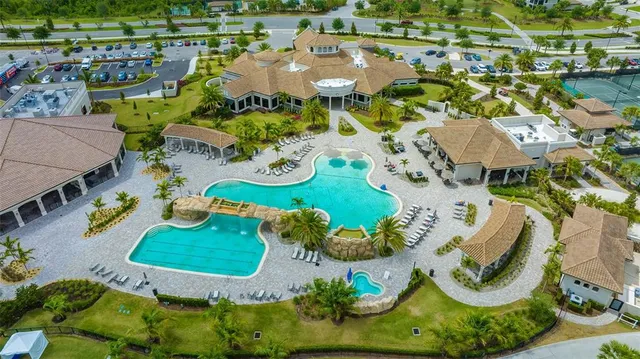 a view of a house with swimming pool and sitting area