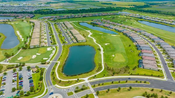 a dining room with furniture a chandelier and outdoor view