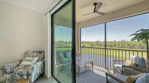 a view of a chair and tables in the balcony