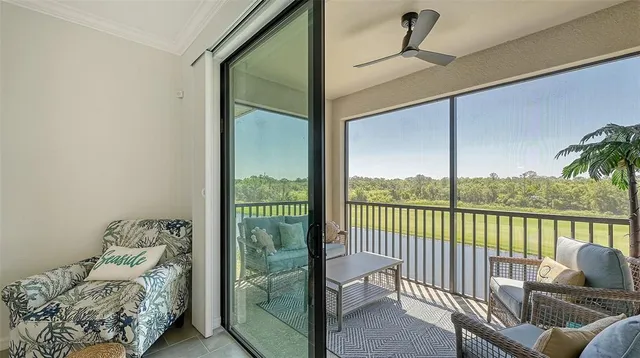 a view of a chair and tables in the balcony
