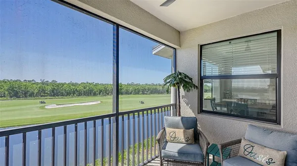 a view of a dining room and livingroom with furniture wooden floor and windows