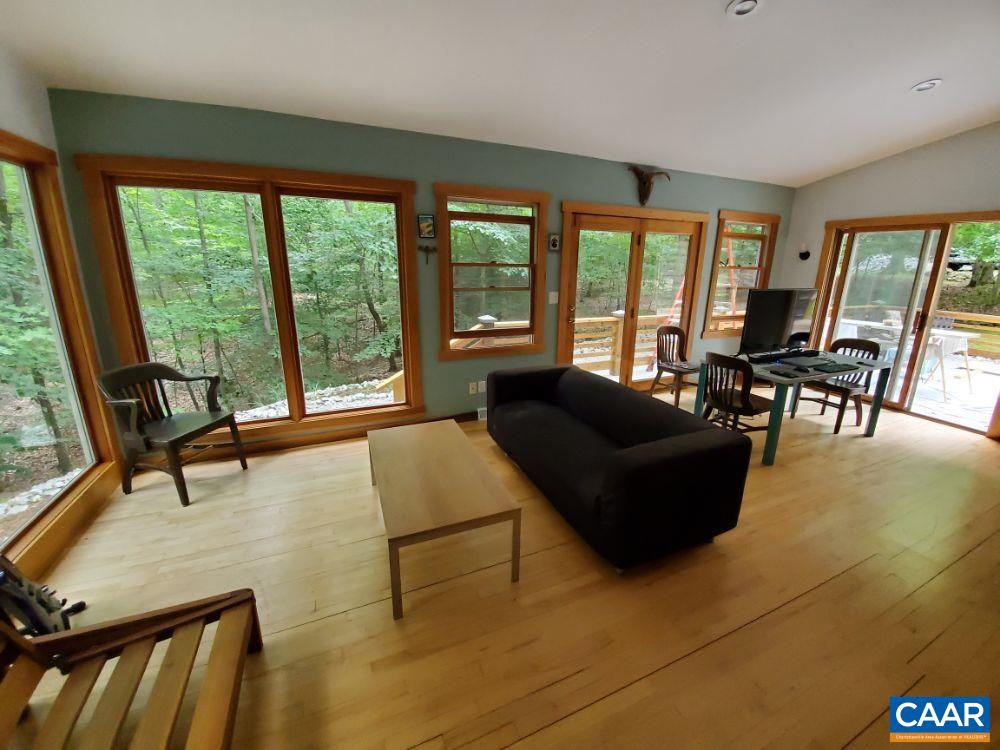 1108 Berry Hill Road Nellysford, VA 22958 - Photo 5 of 32 a living room with furniture and floor to ceiling windows