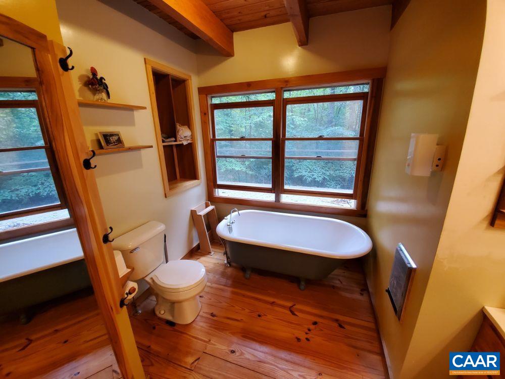 1108 Berry Hill Road Nellysford, VA 22958 - Photo 7 of 32 a bathroom with a toilet a sink and a mirror