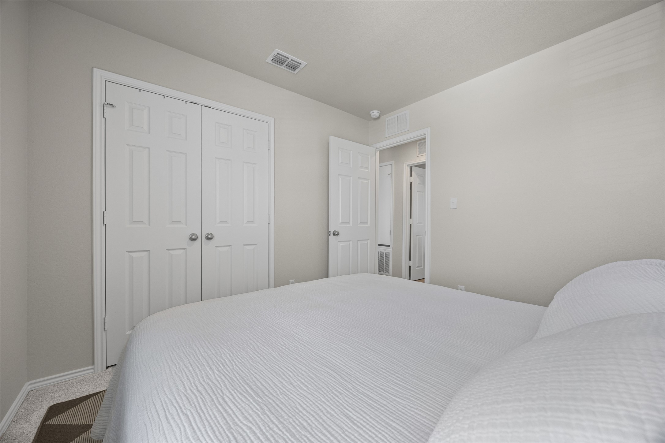 208 Orange Road Buda, TX 78610 - Photo 20 of 31 A comfortable bedroom features plush carpeting and convenient closet access.