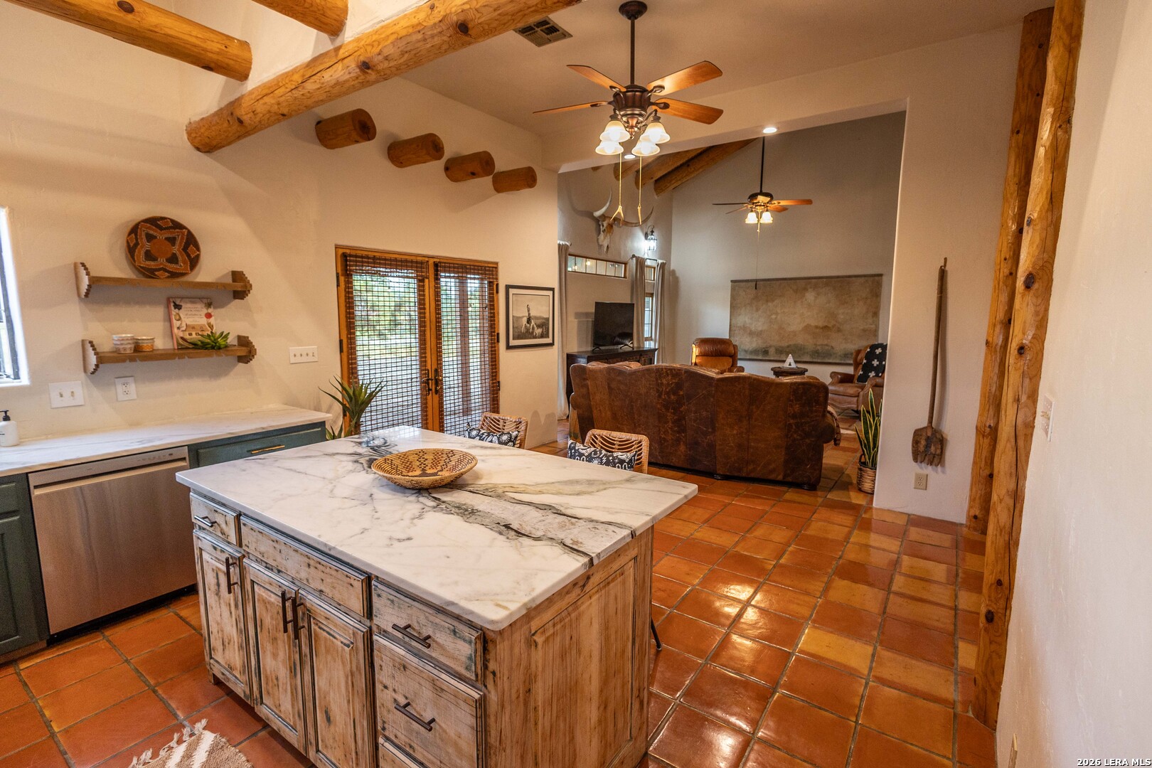 5499 Agape Road Uvalde, TX 78801 - Photo 20 of 54 a kitchen with kitchen island granite countertop a sink stove and refrigerator
