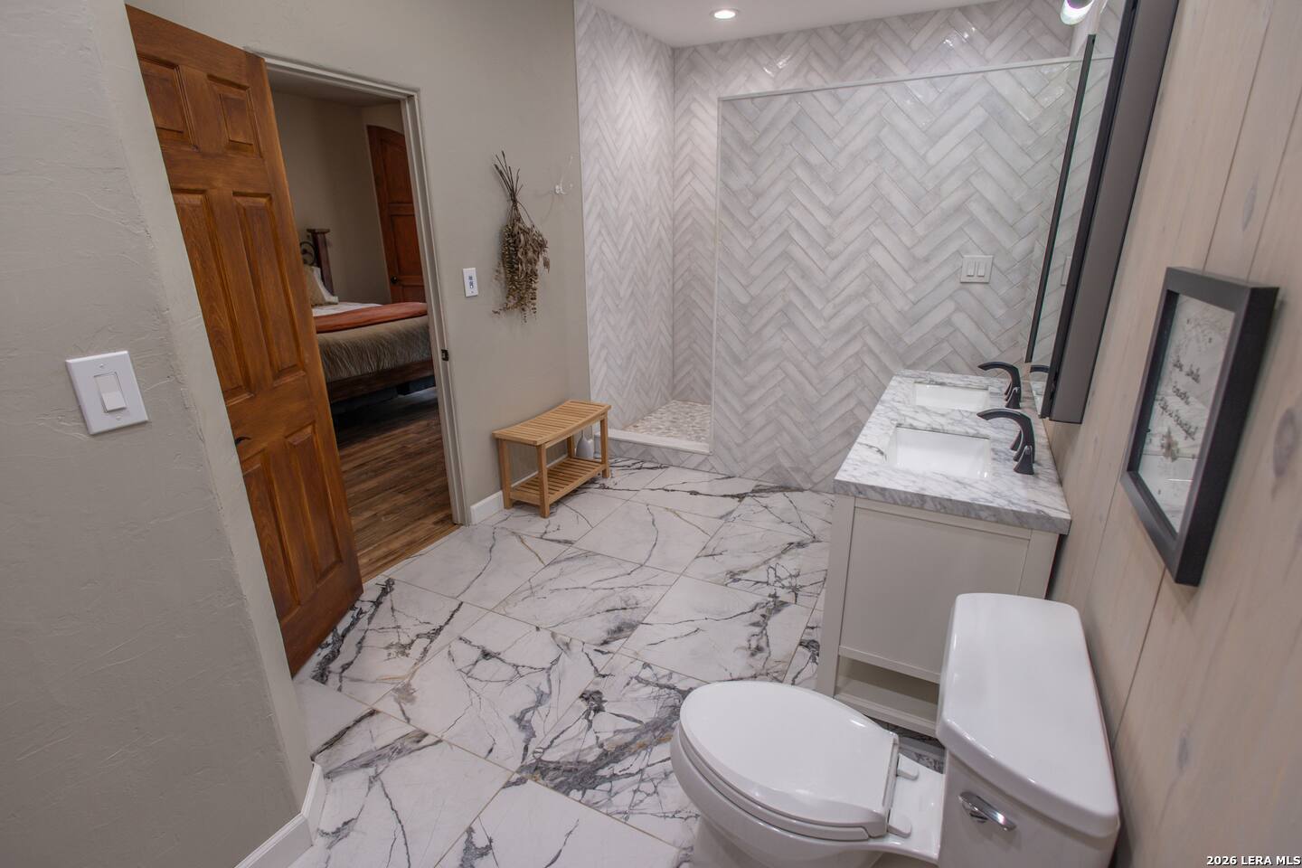 5499 Agape Road Uvalde, TX 78801 - Photo 41 of 54 a white toilet sitting next to a bathroom sink and a mirror