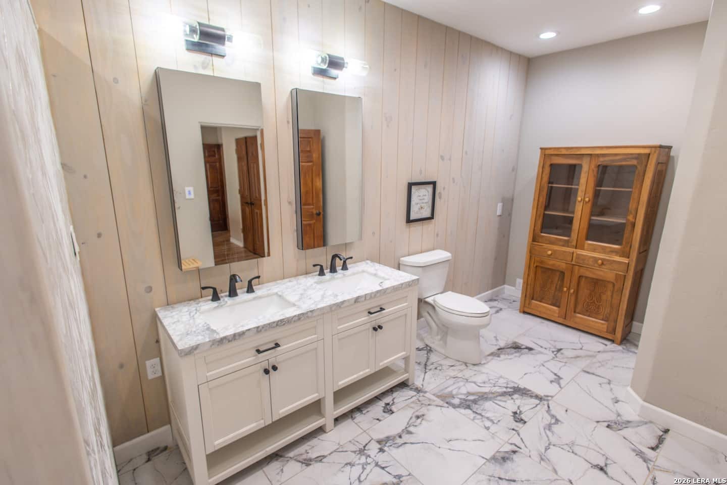 5499 Agape Road Uvalde, TX 78801 - Photo 42 of 54 a bathroom with a double vanity sink mirror and toilet
