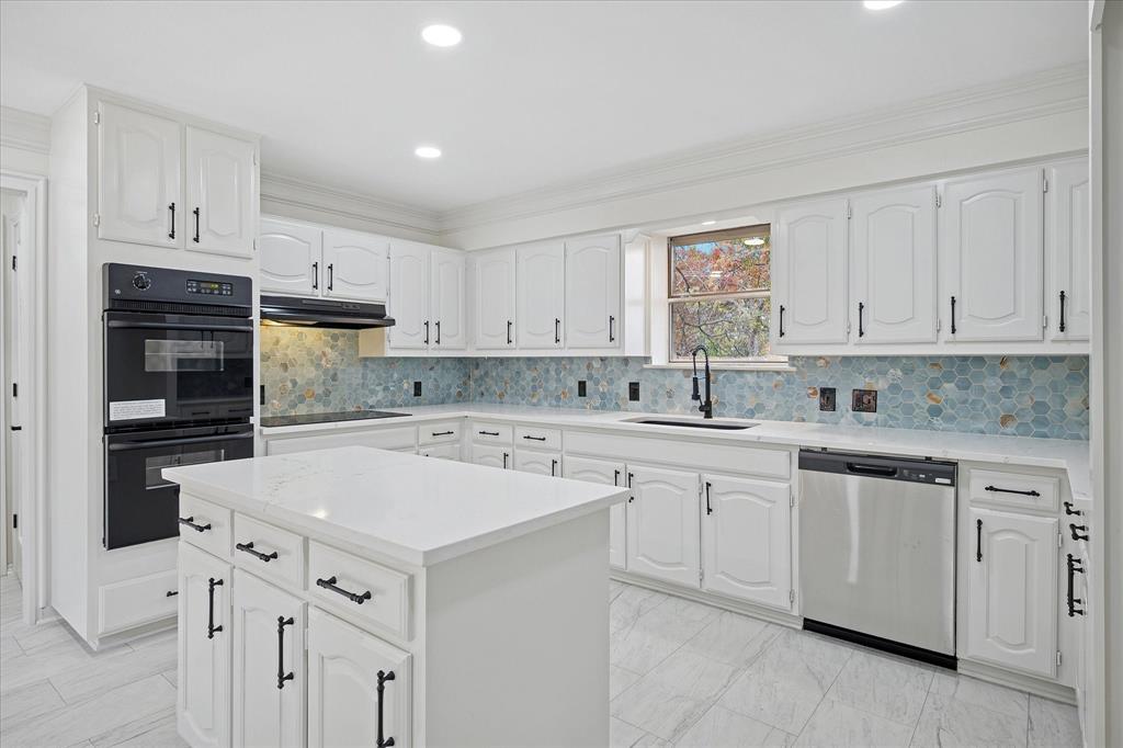 62 Legend Road Benbrook, TX 76132 - Photo 8 of 27 The heart of this home is the spacious gourmet island kitchen featuring double ovens, electric cook top, abundance of cabinets and counter space. Large walk-in pantry and additional pantry space by back door to garage.