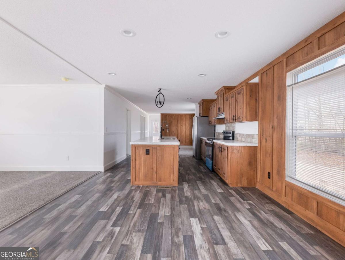 5222 Bogus Road Gainesville, GA 30506 - Photo 13 of 43 a large kitchen with wooden floor and stainless steel appliances