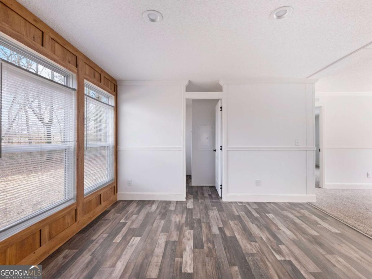 5222 Bogus Road Gainesville, GA 30506 - Photo 15 of 43 a view of empty room with wooden floor and fan