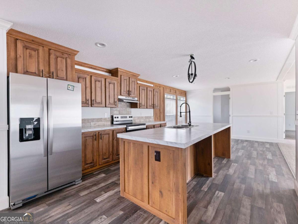 5222 Bogus Road Gainesville, GA 30506 - Photo 16 of 43 a kitchen with stainless steel appliances granite countertop a sink stove and refrigerator