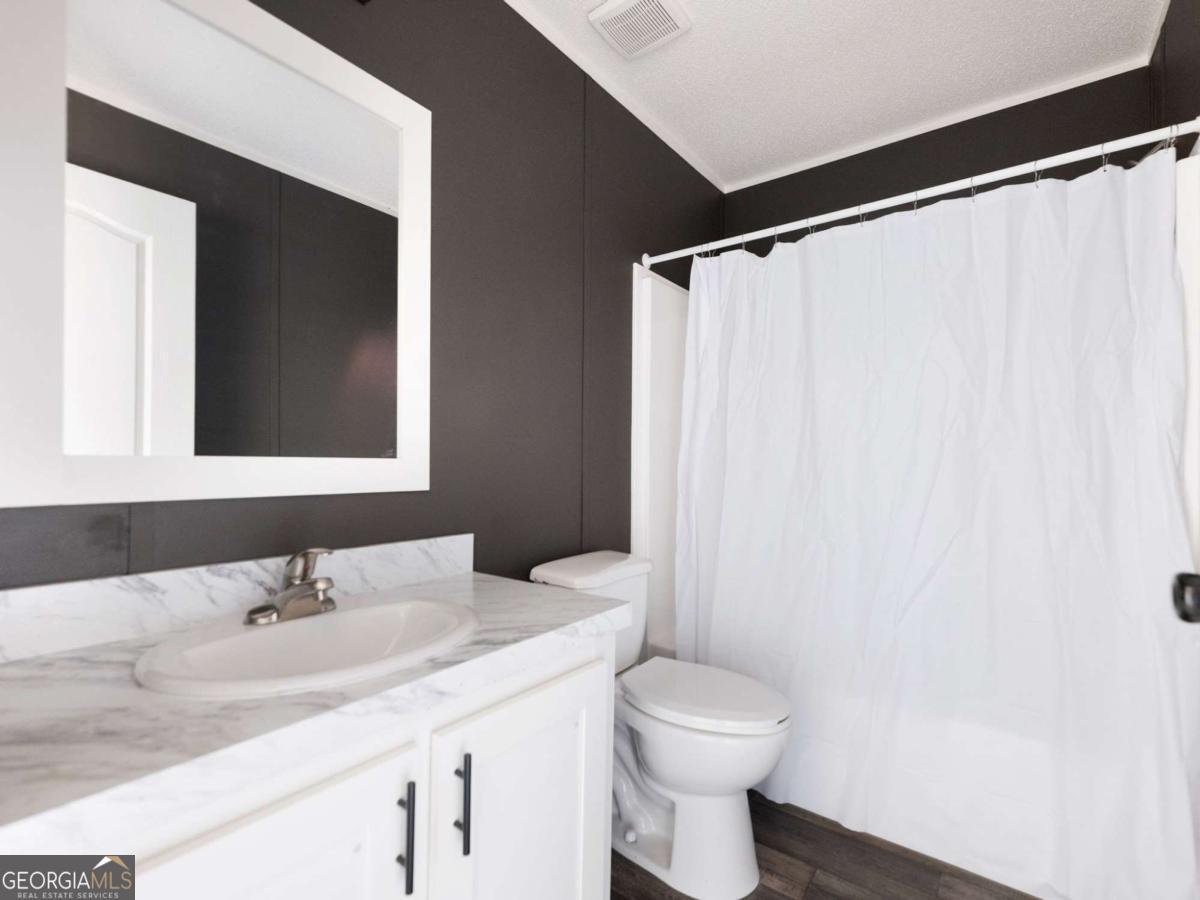 5222 Bogus Road Gainesville, GA 30506 - Photo 28 of 43 a bathroom with a sink and a mirror