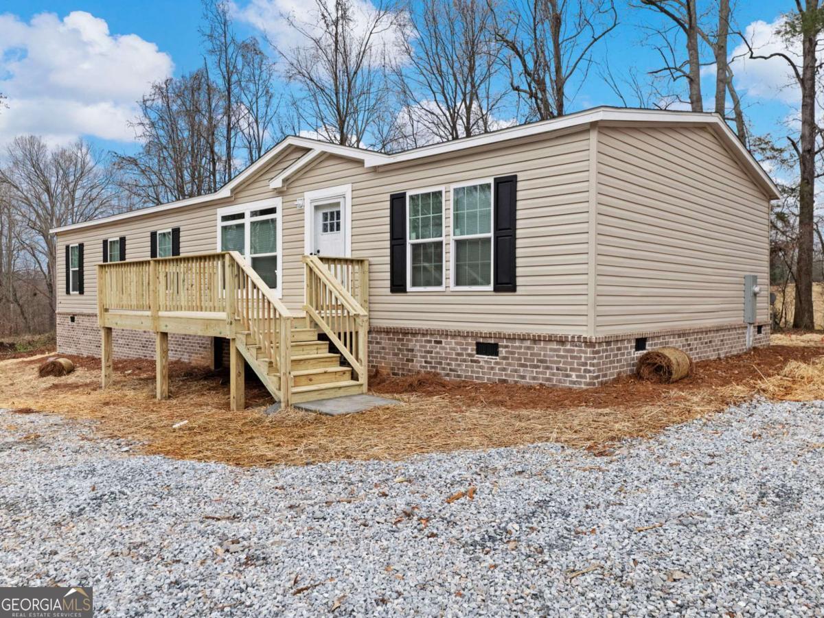 5222 Bogus Road Gainesville, GA 30506 - Photo 34 of 43 a view of a house with a yard
