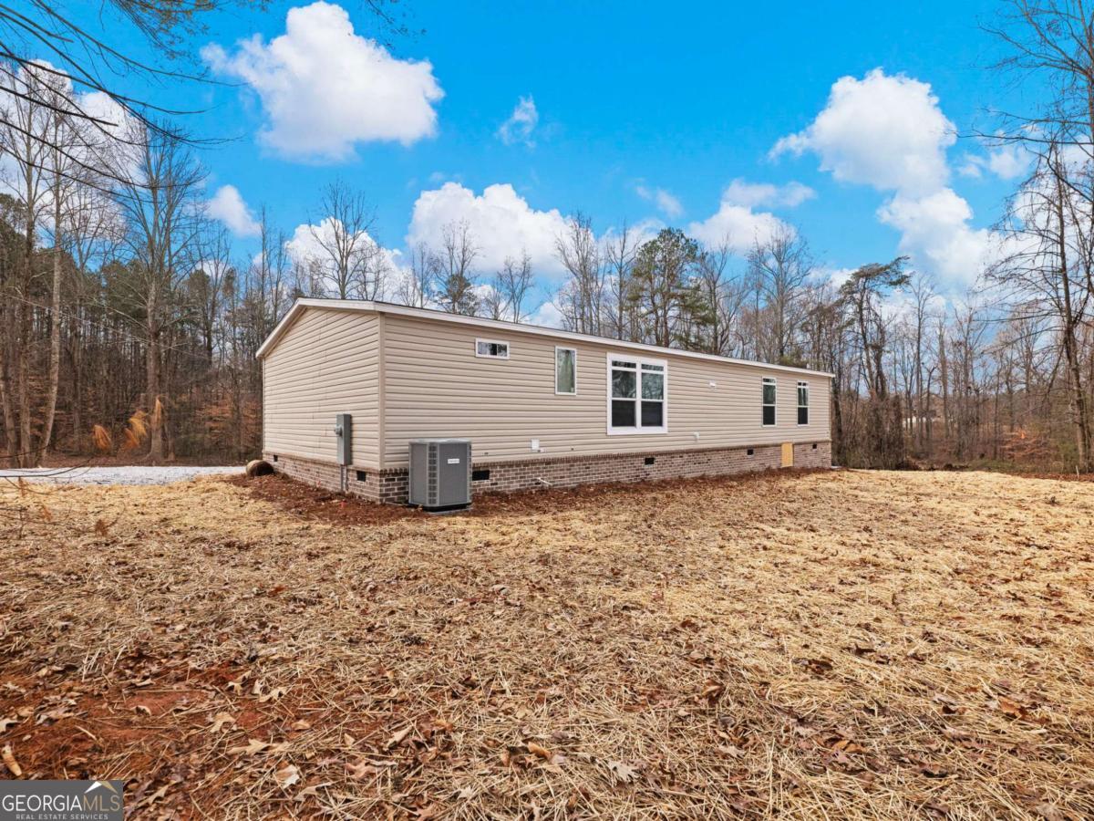 5222 Bogus Road Gainesville, GA 30506 - Photo 36 of 43 a view of a house with a yard