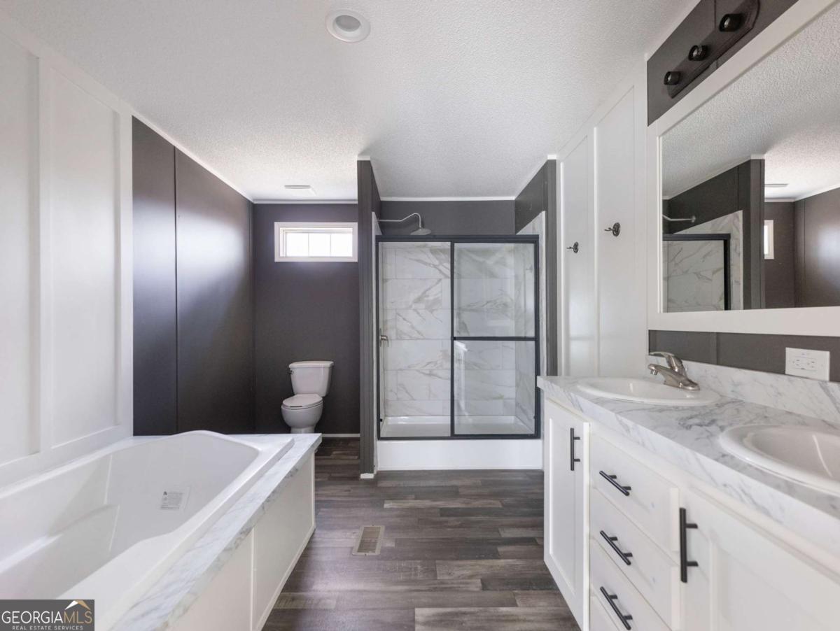 5222 Bogus Road Gainesville, GA 30506 - Photo 9 of 43 a bathroom with a tub sink and mirror